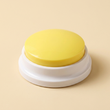 WordyPaws talking button in Macaron Yellow on a cream studio background