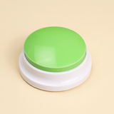 WordyPaws talking button in Macaron Green on a cream studio background