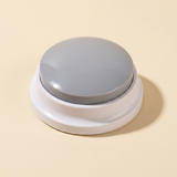WordyPaws talking button in Macaron Gray on a cream studio background