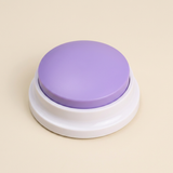 WordyPaws talking button in Macaron Purple on a cream studio background